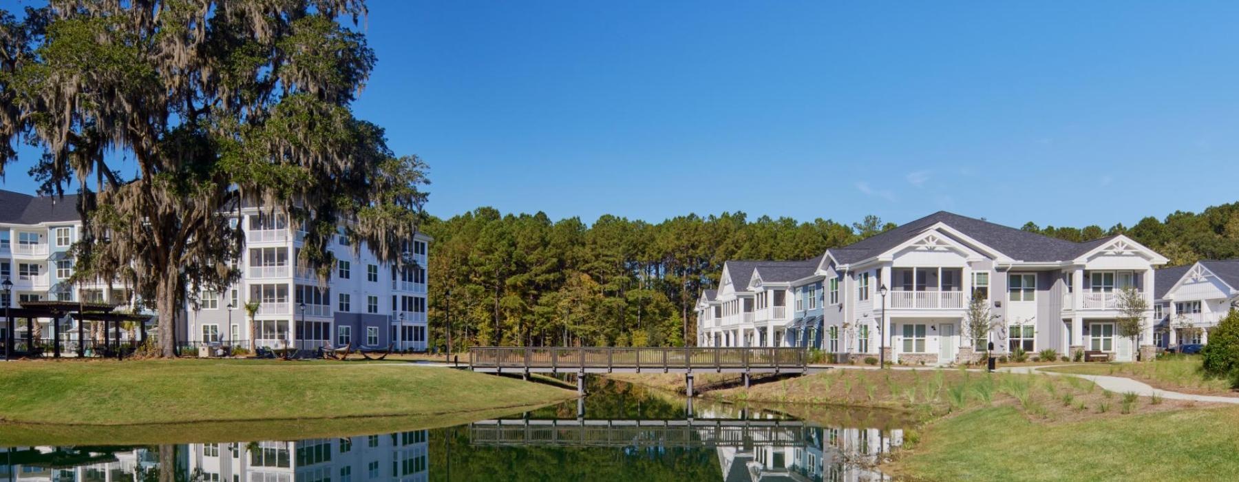 a row of houses next to a pond