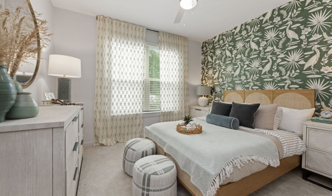 Generous bedroom offerings to fit every family  a bedroom with a bed and a lamp