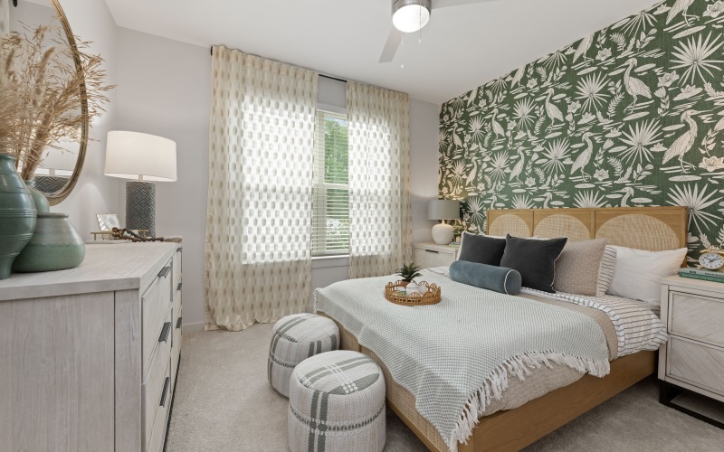 a  bedroom with a bed and a fan