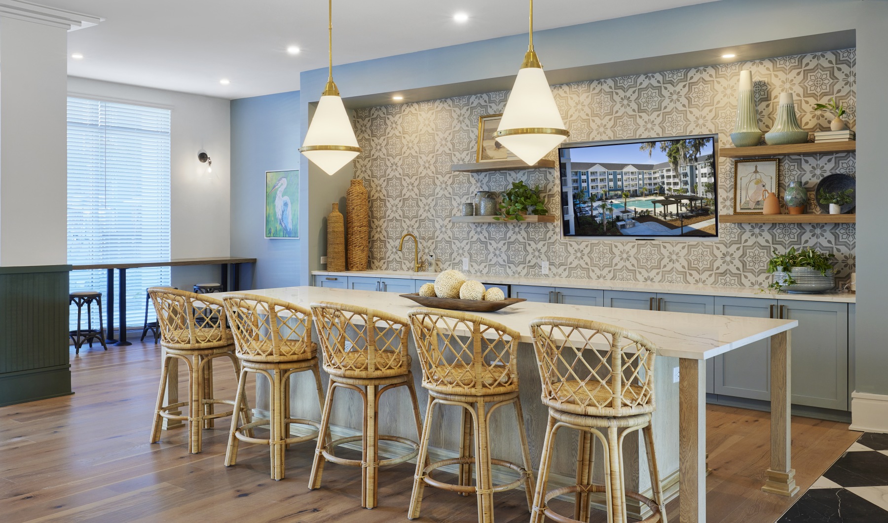 a kitchen with a bar and chairs