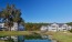 a row of houses next to a pond